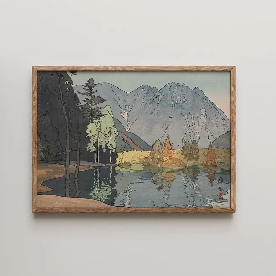 Framed painting of a serene landscape featuring mountains, trees, and a calm lake with reflections.