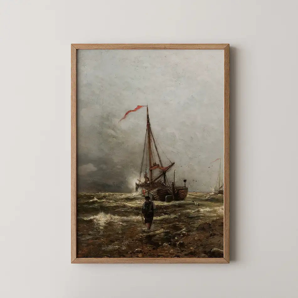 Painting of a coastal scene featuring a fishing boat with red sails in rough waters, accompanied by a figure walking on the shore, displayed in a wooden frame.