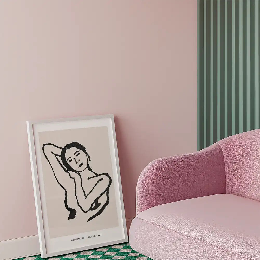 Modern minimalist poster featuring a graceful female figure, framed in white, set against a soft pastel pink background, ideal for contemporary home decor.
