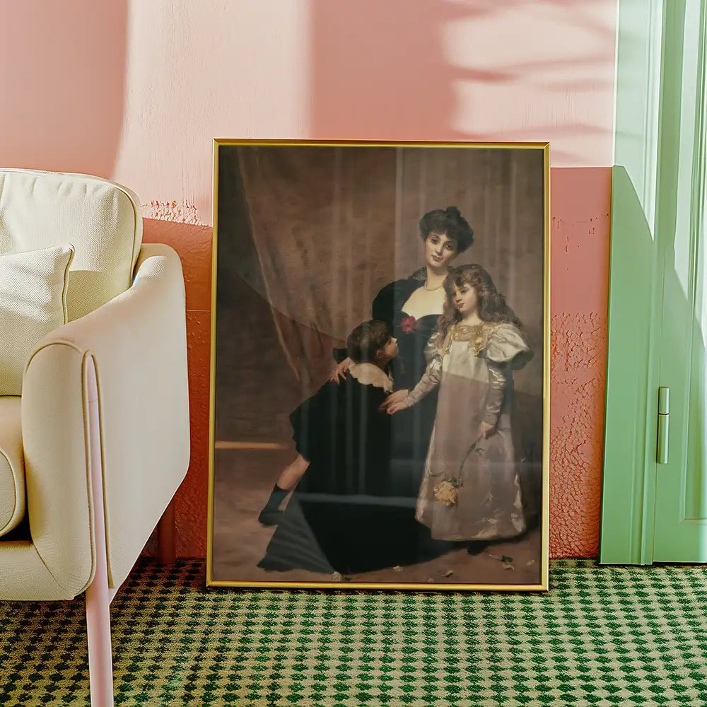 Framed vintage painting of a woman and two children, displayed beside a light-colored armchair in a stylish interior setting.