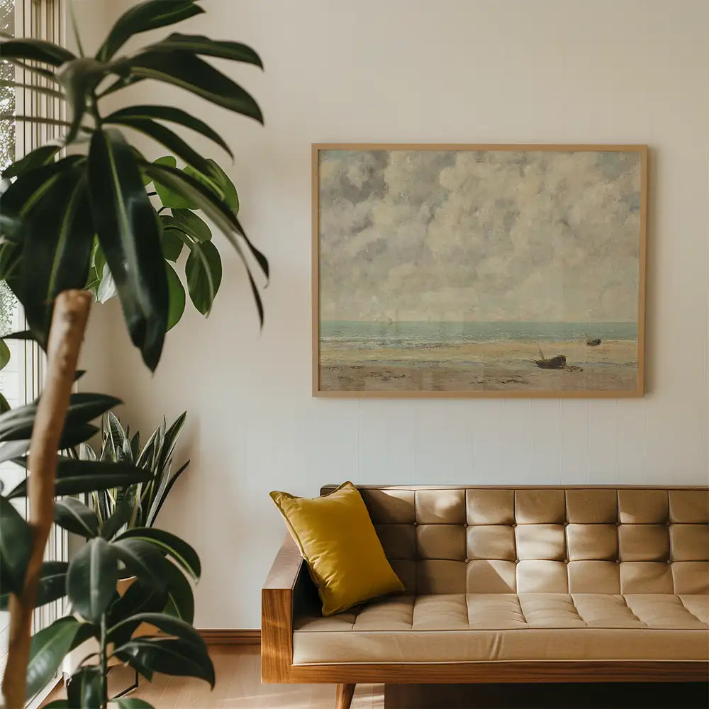 Framed painting of a seascape with clouds and boats, displayed on a wall above a modern tan sofa with a yellow cushion, surrounded by indoor plants.