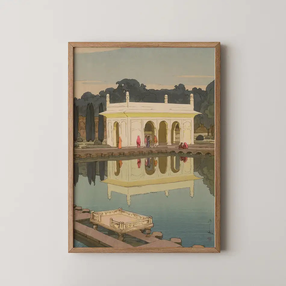Framed painting of a serene architectural structure reflected in water, surrounded by greenery and people engaging in leisurely activities.