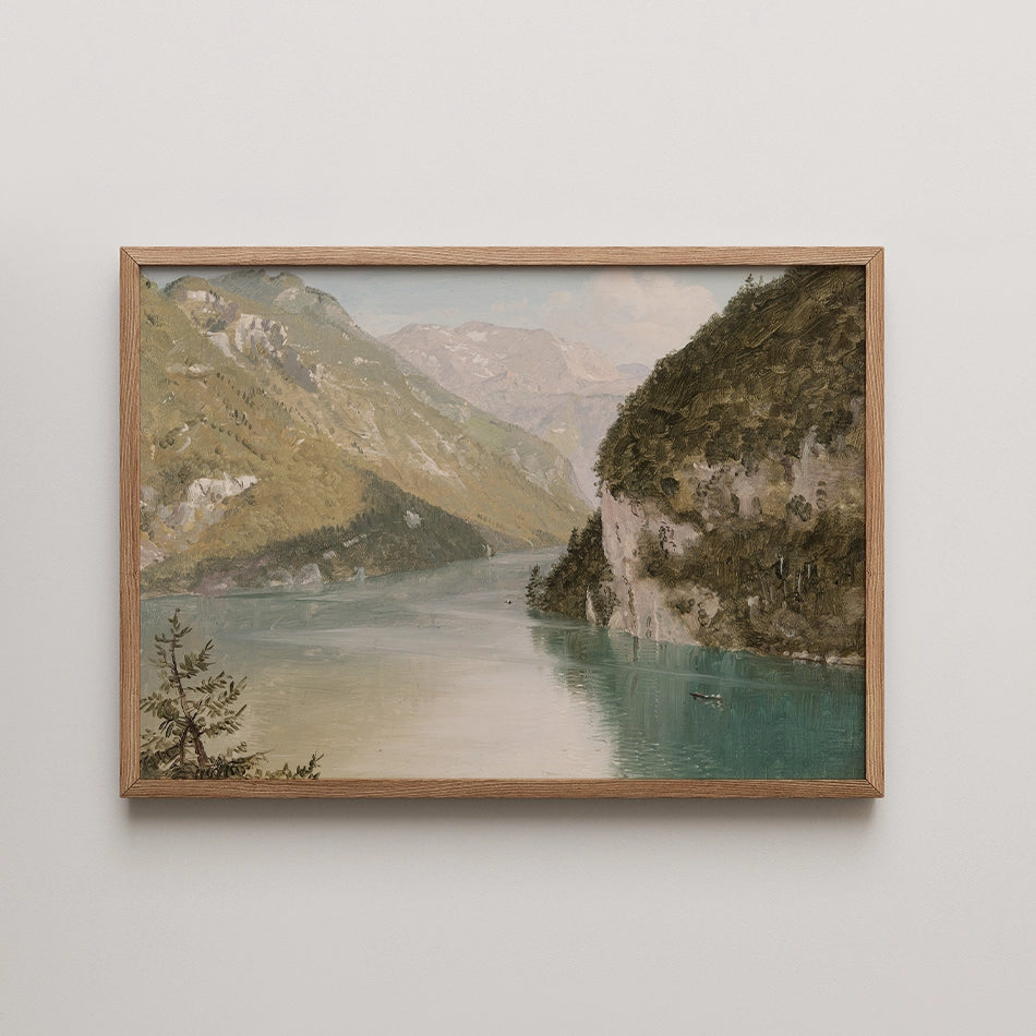 Framed painting of a serene landscape featuring a lake surrounded by mountains and greenery.