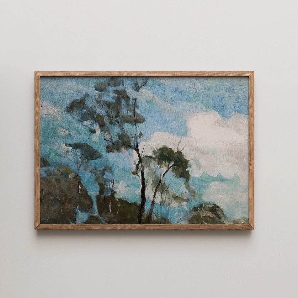 A painting featuring trees against a blue sky with clouds, framed in natural wood.