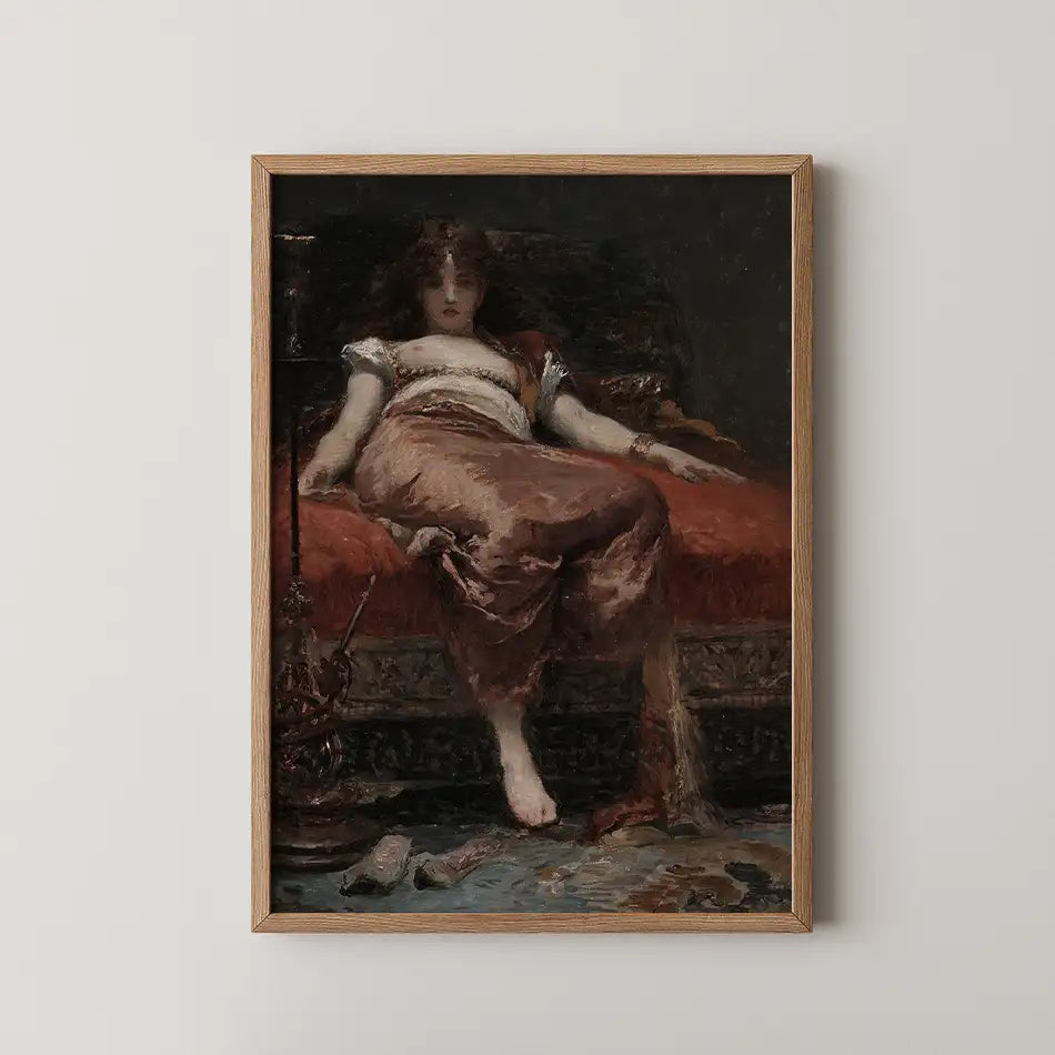 Framed painting of a reclining woman in traditional attire, lounging on a richly decorated couch.