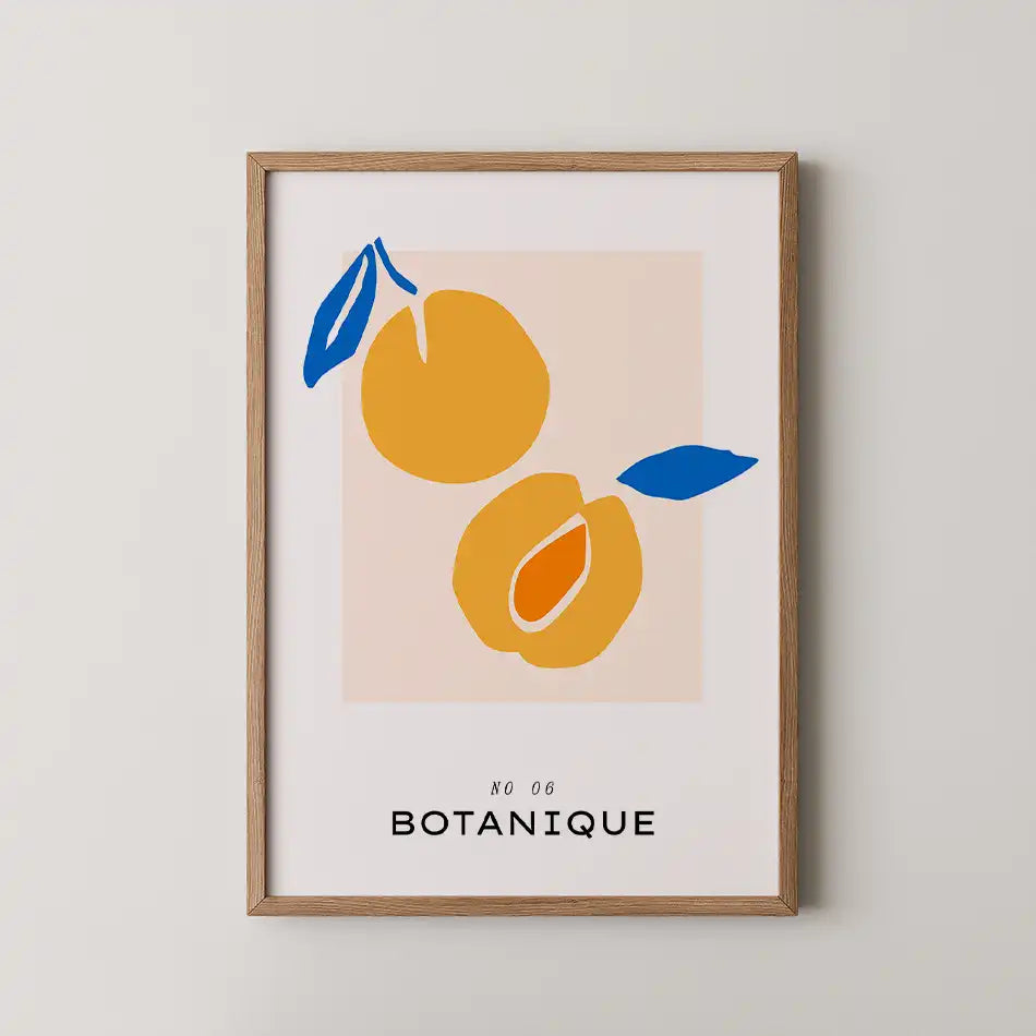 Modern art print 'Golden Halves' featuring two vibrant golden fruits with blue leaves on a peach-toned background, complemented by elegant typography reading 'BOTANIQUE'"