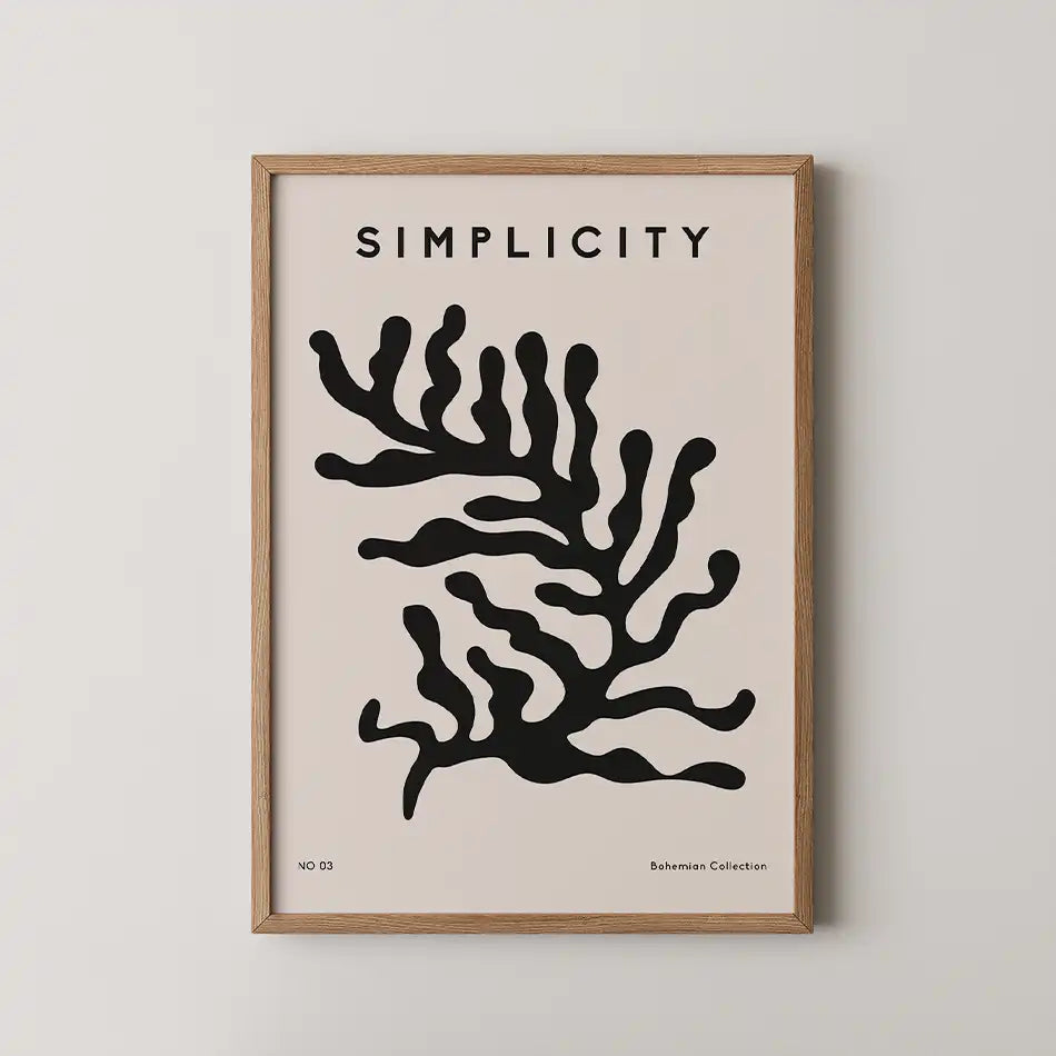 Minimalist art print featuring a black silhouette of seaweed on a blush pink background, framed in natural wood, from the Bohemian Collection.