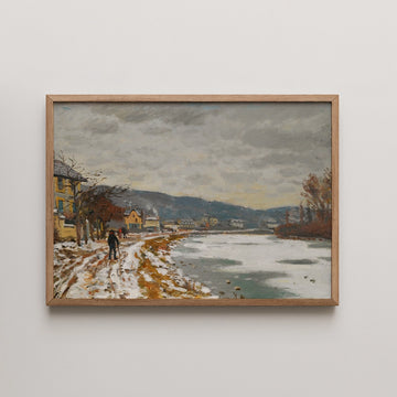 Framed painting of a snowy riverside scene with dark clouds, trees, and distant houses.