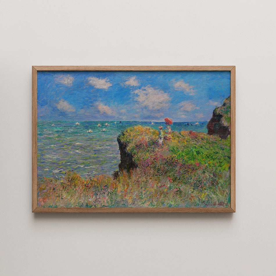 Painting of a coastal scene featuring two figures on a grassy cliff overlooking the ocean with boats sailing and a bright blue sky.