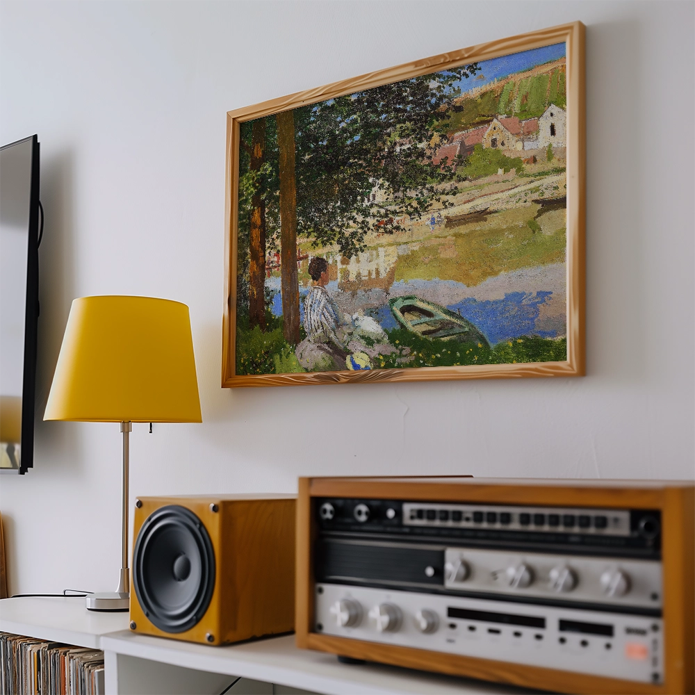 A colorful landscape painting featuring a figure sitting by a river, surrounded by trees and quaint houses, framed and displayed alongside a yellow lamp and vintage audio equipment.