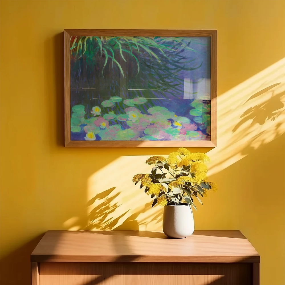 Framed painting of water lilies on a yellow wall with a vase of yellow flowers on a wooden table.