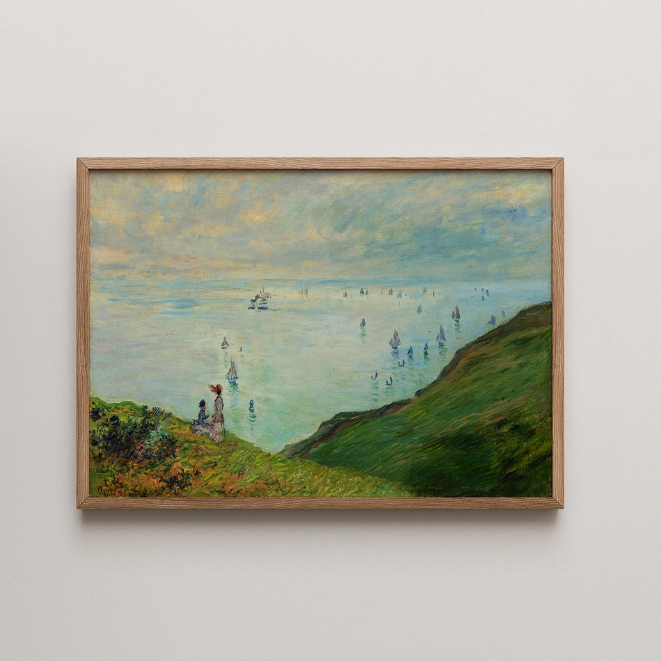Framed painting of a serene landscape featuring two figures on a cliff overlooking a bay filled with sailboats under a cloudy sky.