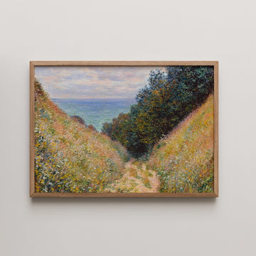 Framed landscape painting depicting a pathway through vibrant foliage leading to a serene ocean view under a cloudy sky.