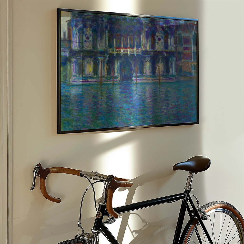 Painting of a colorful waterfront building framed on a wall beside a vintage bicycle.
