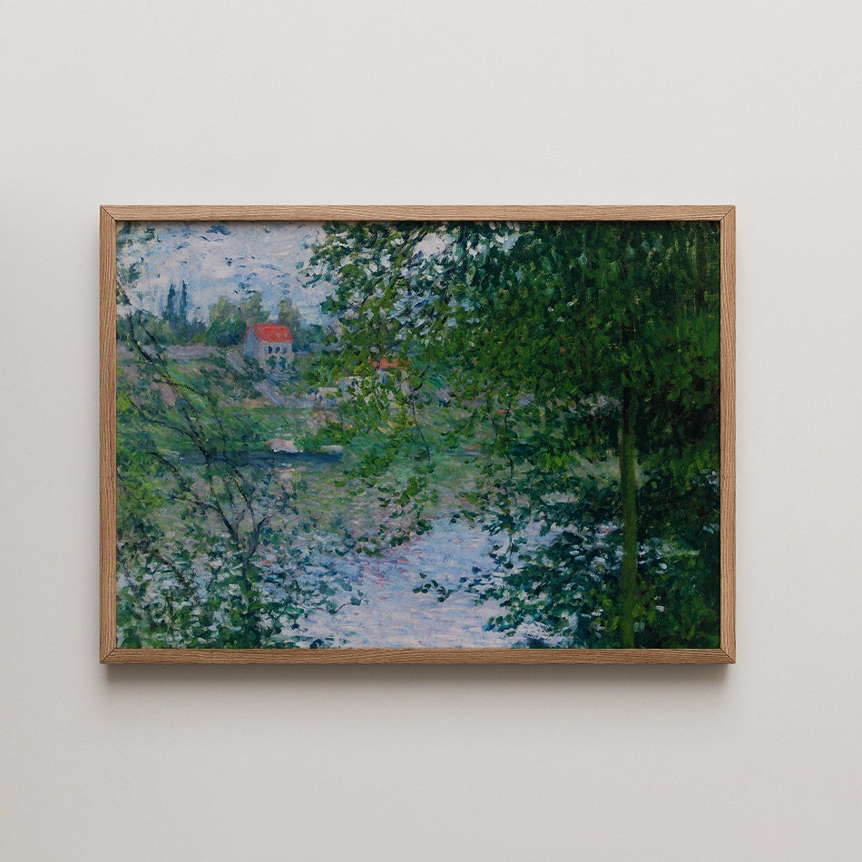 Painting of a tranquil landscape featuring a river, lush greenery, and a red-roofed house in the background, framed in light wood.