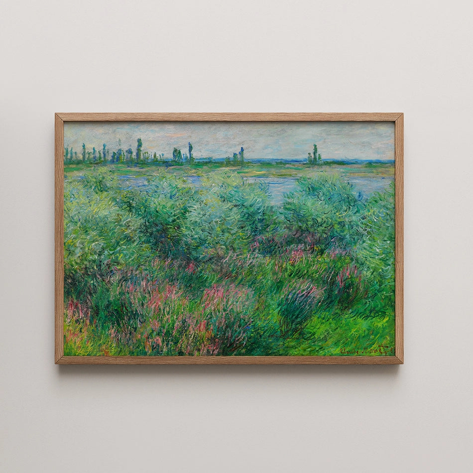 Framed painting of a lush green landscape with colorful wildflowers and a serene river in the background.