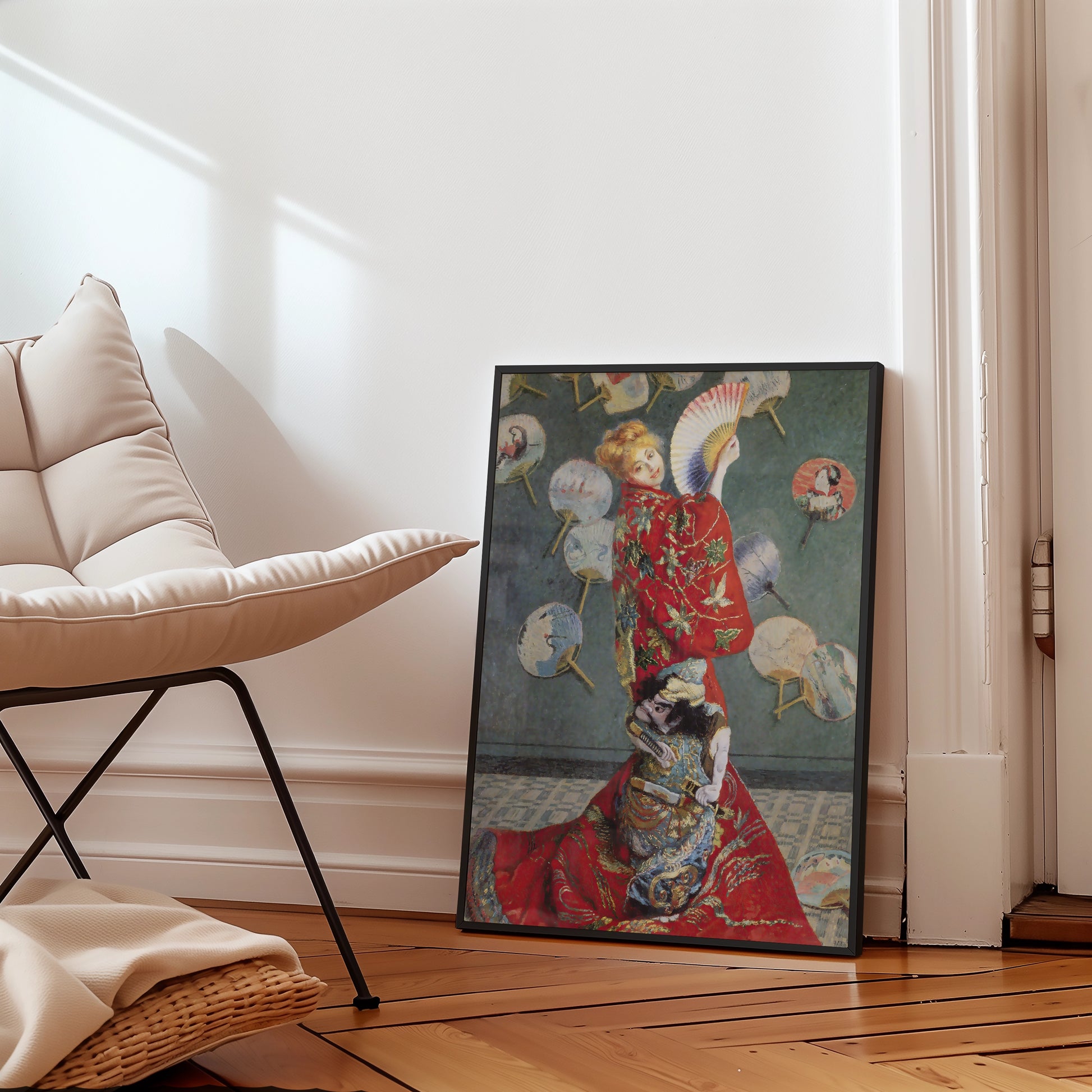 Framed painting of a woman in a red kimono with fans on the wall behind her, leaning against a modern chair in a bright room.