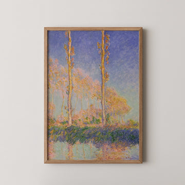 Framed painting of trees with pink leaves reflecting in water under a blue sky.