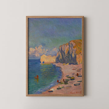 Painting of a scenic beach with cliffs, boats on the water, and vibrant clouds, framed in wood.
