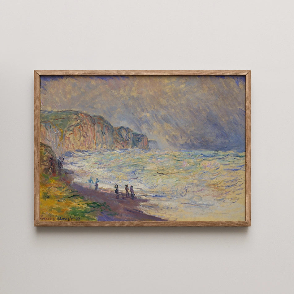 Painting of a beach scene with figures by the shore and cliffs in the background, framed in wood.
