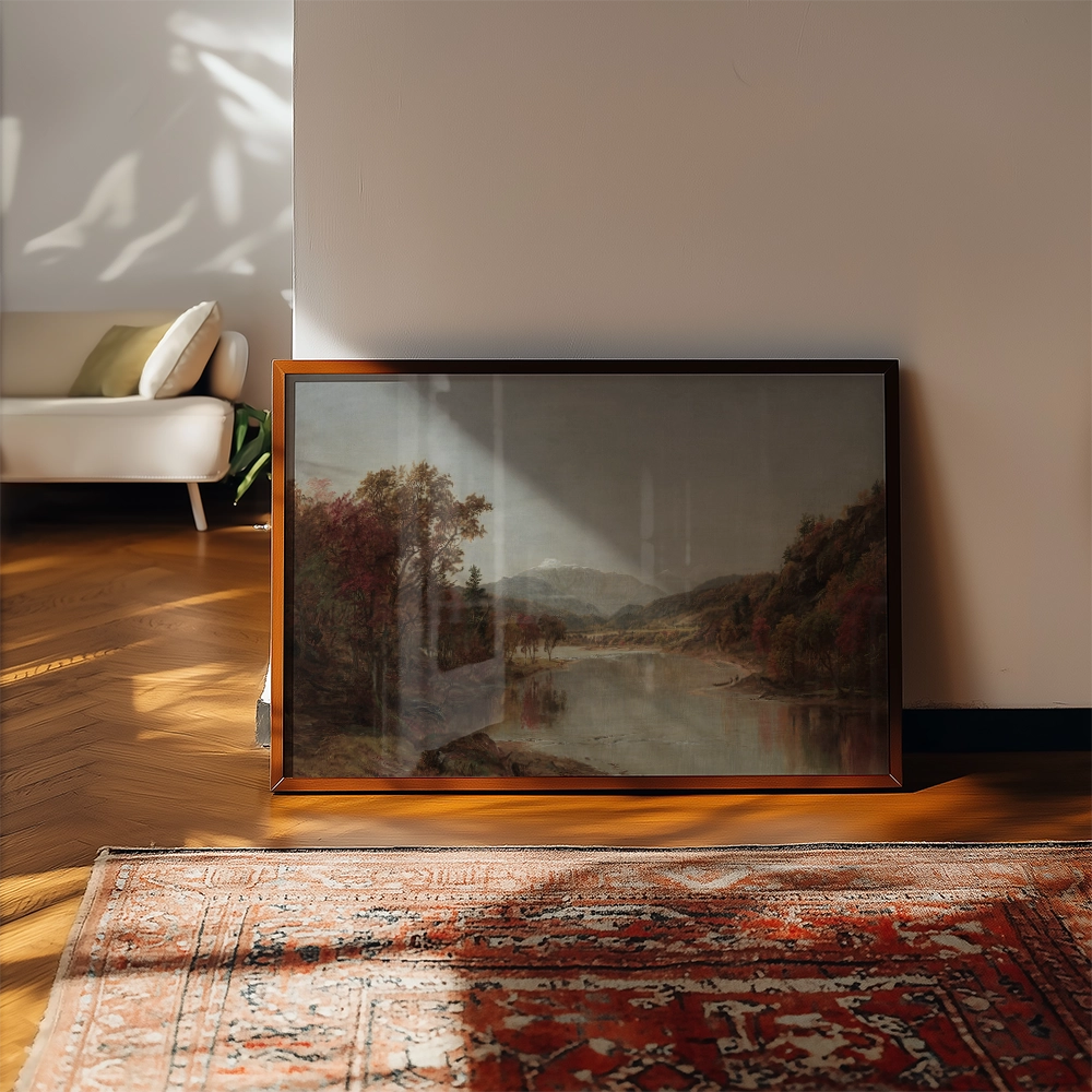 Framed landscape painting featuring a river, mountains, and colorful trees, displayed in a bright, modern room with wooden flooring and a patterned rug.