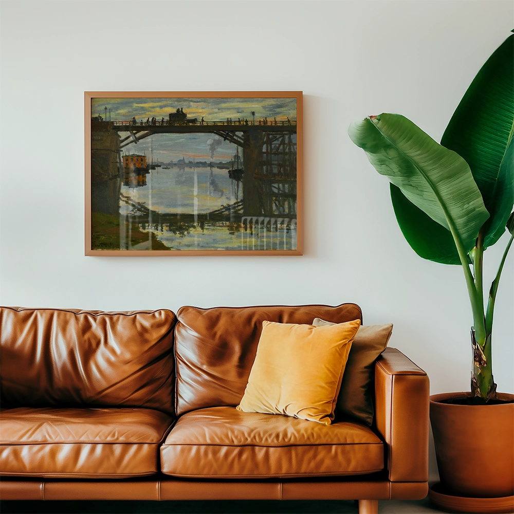 Framed painting of a bridge and water scene above a brown leather sofa with yellow cushions and a green plant.