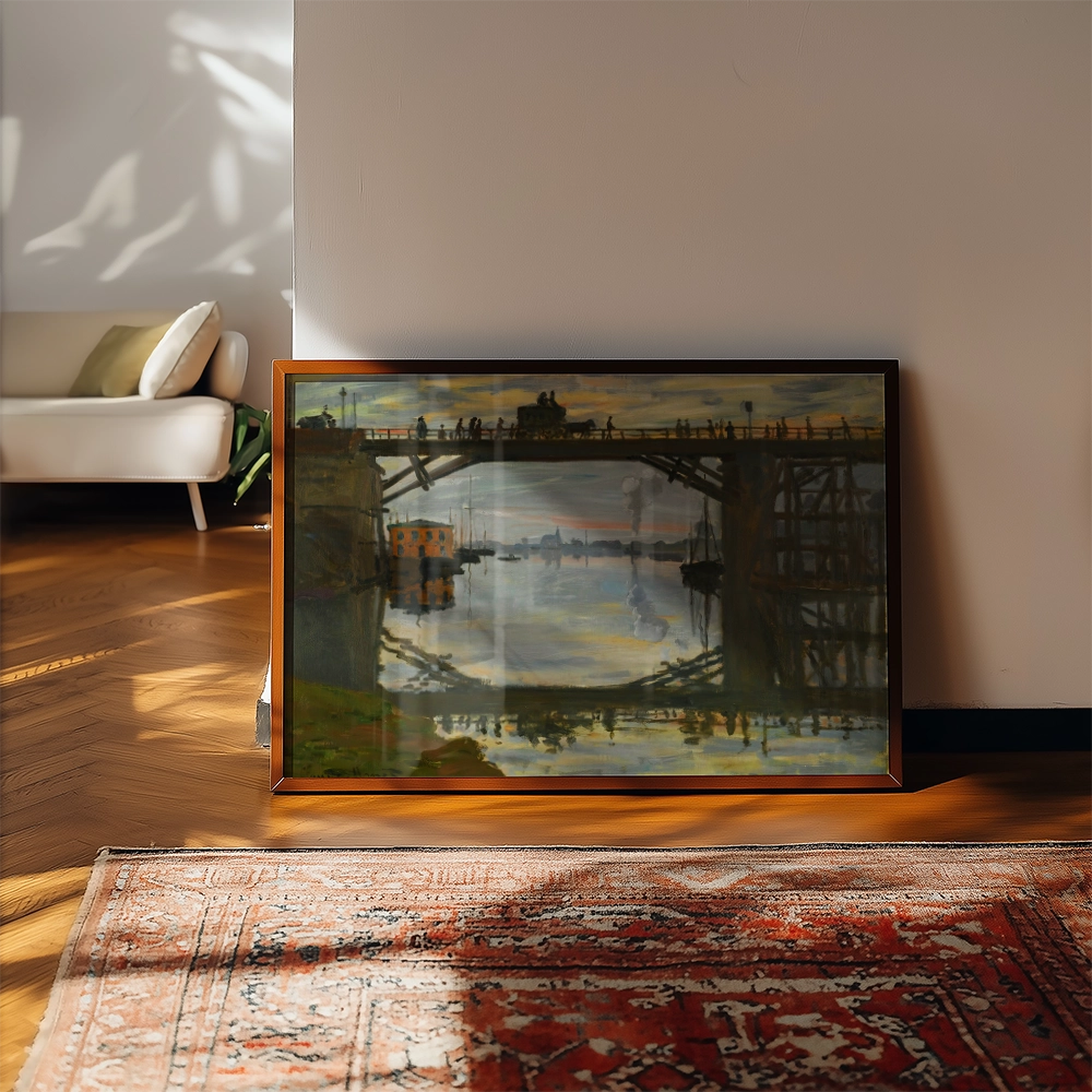 A framed painting of a bridge at sunset, reflecting in the water, displayed in a cozy interior setting with a plush sofa and patterned rug.