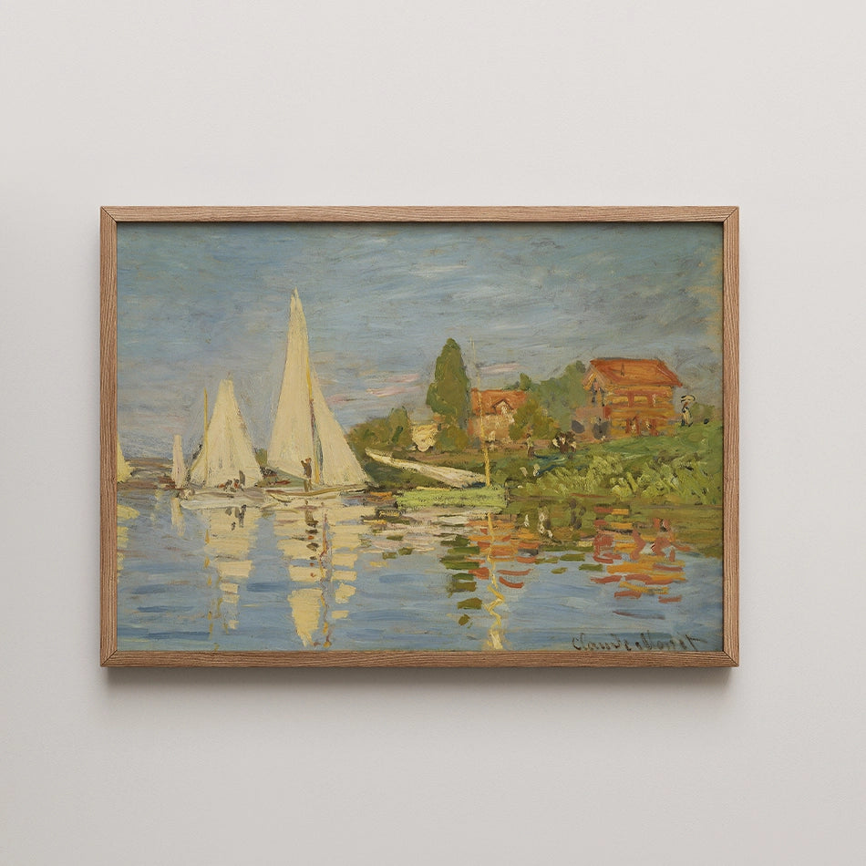 Painting of a serene lakeside scene featuring sailboats and charming houses, framed in natural wood.
