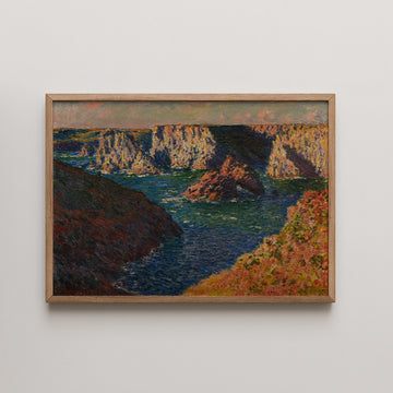 Landscape painting of rocky cliffs and a serene body of water, framed in light wood.