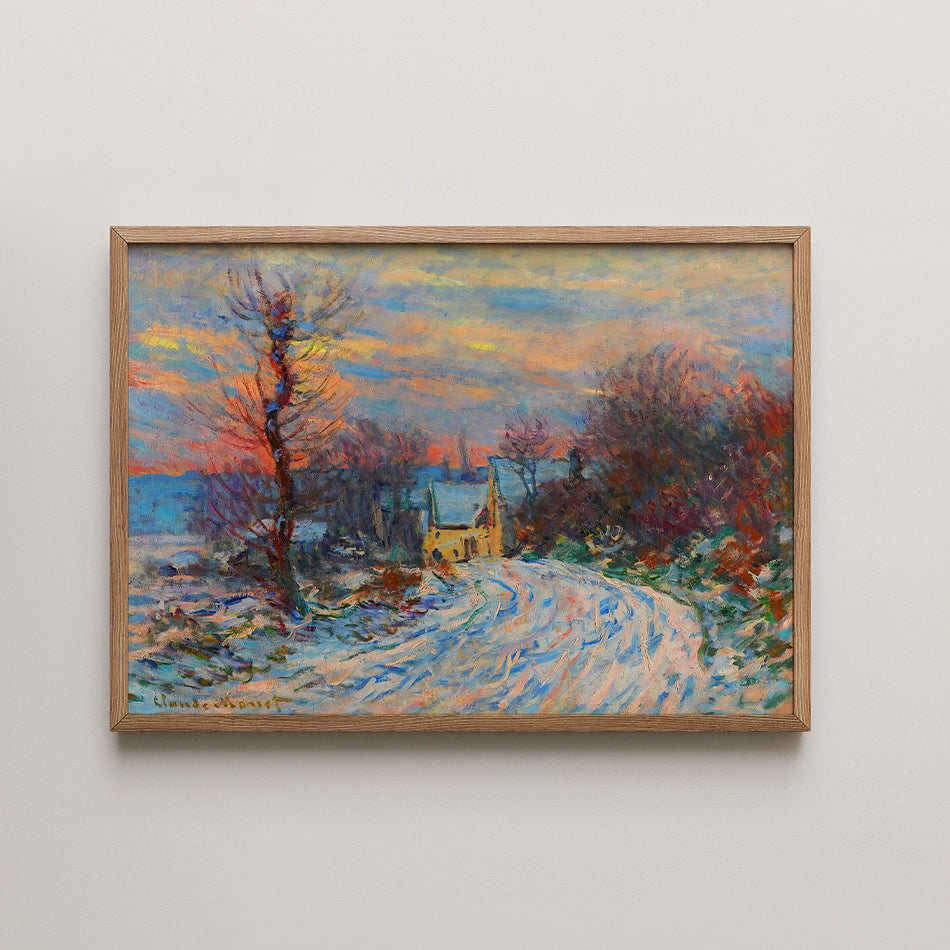 Winter landscape painting with a snowy road leading to a yellow house, framed in natural wood.