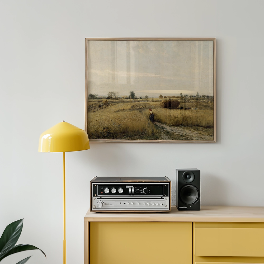 Framed landscape painting above a modern yellow lamp and vintage audio equipment on a light wood cabinet.