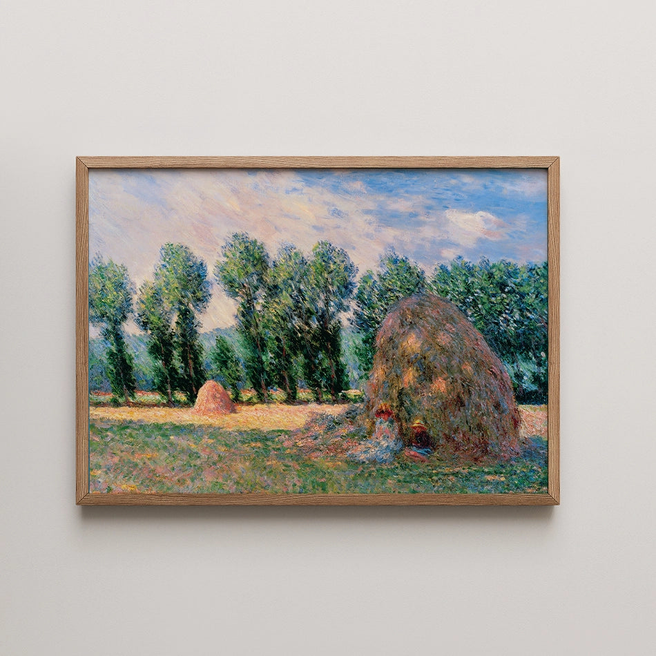 Painting of a rural landscape featuring haystacks and tall trees under a blue sky, framed in a wooden frame.