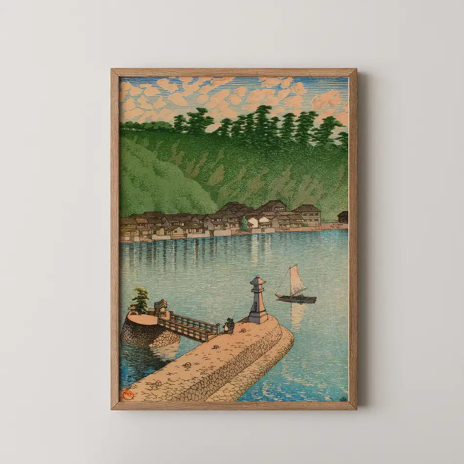 Painting of a serene riverside scene featuring a small boat, a bridge, and a lighthouse, surrounded by lush greenery and traditional houses, framed in wood.
