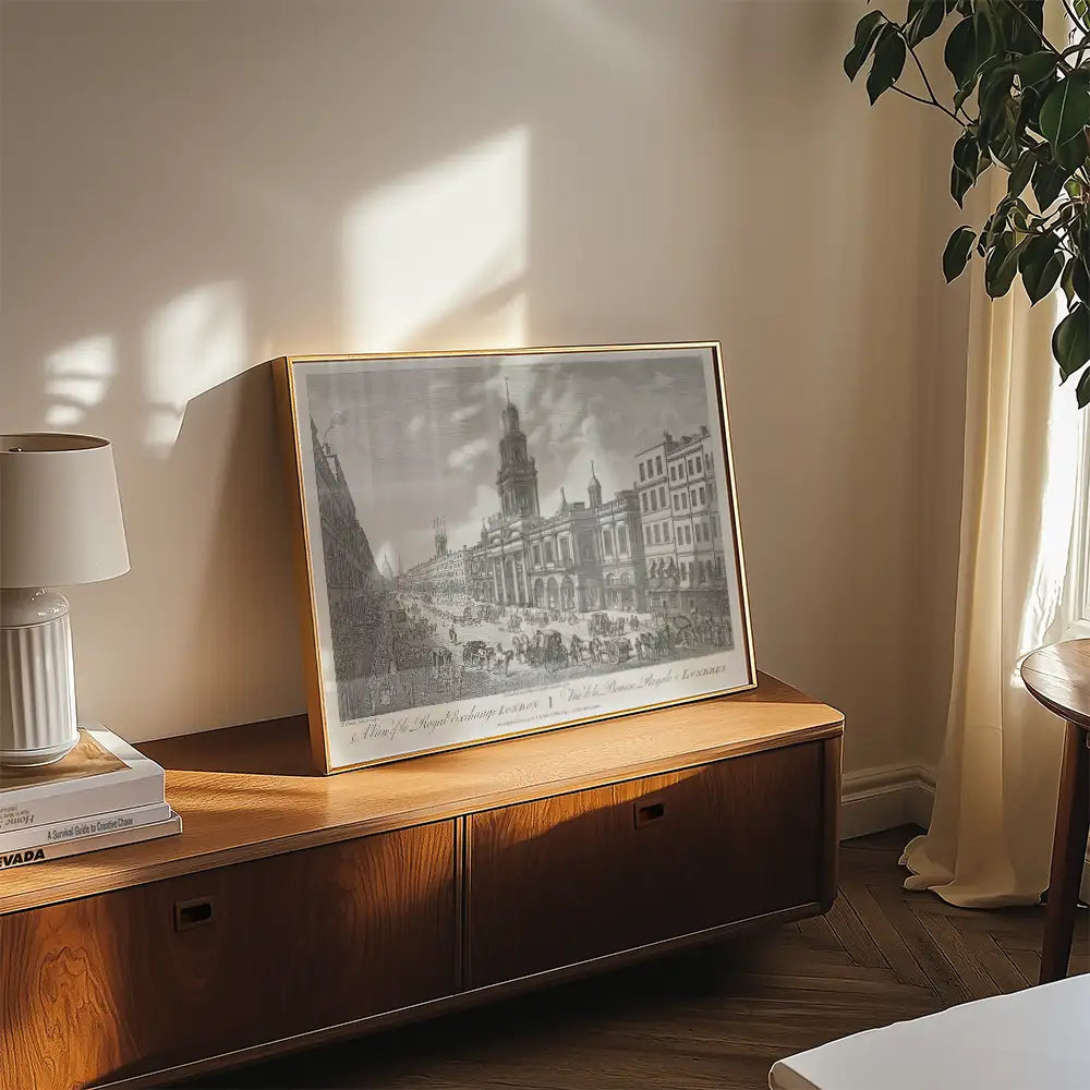 Framed vintage-style painting of a historical cityscape displayed on a wooden console table, with a lamp and decorative items in a sunlit living room.