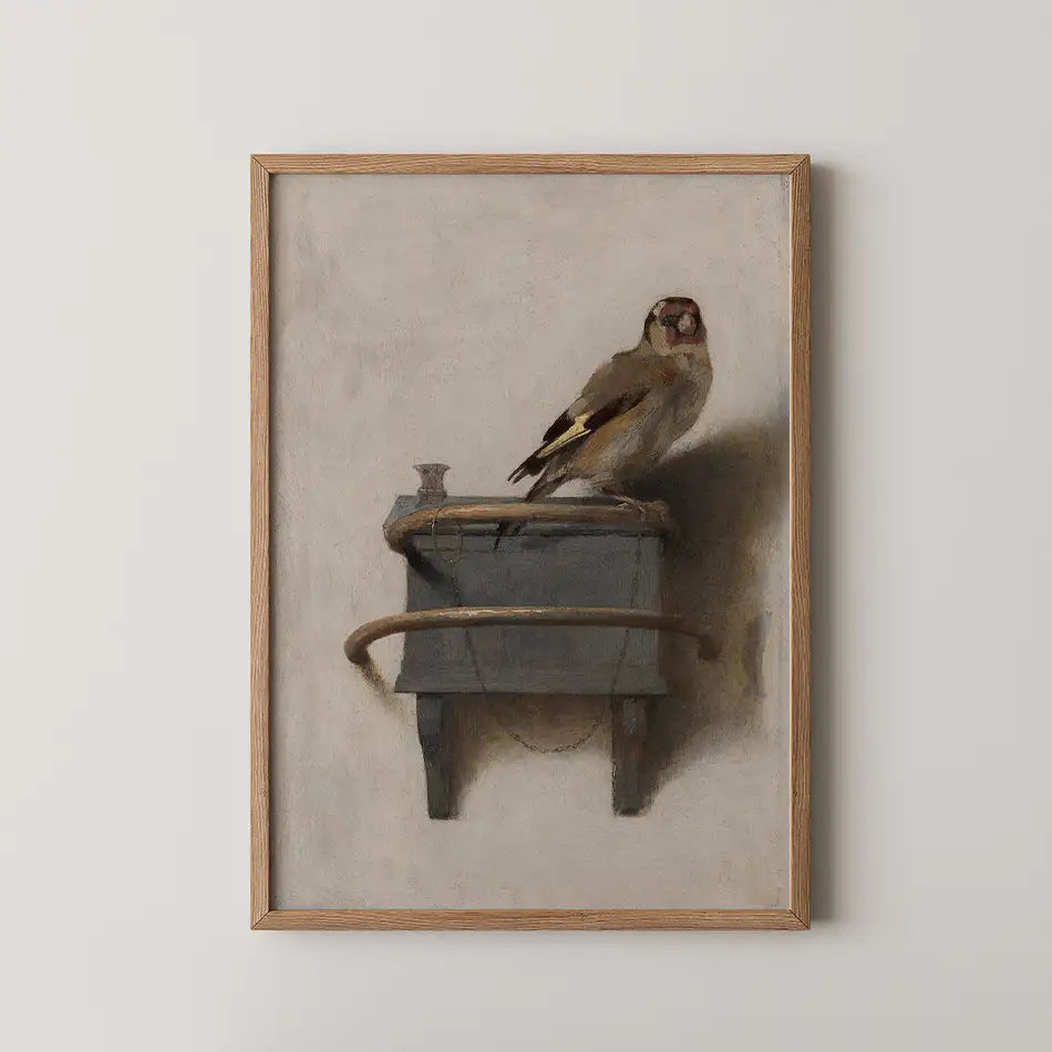 Painting of a goldfinch perched on a wooden box with a matte background, framed in natural wood.