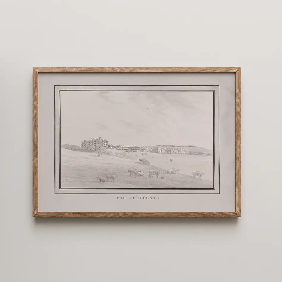 Black and white painting titled "The Crescent" depicting a landscape with cows and buildings in the background, framed in natural wood.