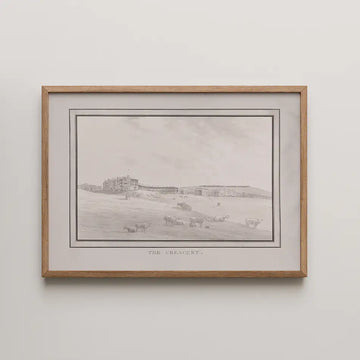 Black and white painting titled "The Crescent" depicting a landscape with cows and buildings in the background, framed in natural wood.