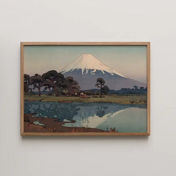 Framed painting of a serene landscape featuring a snow-capped mountain, a tranquil lake, and trees, showcasing soft colors and a peaceful ambiance.