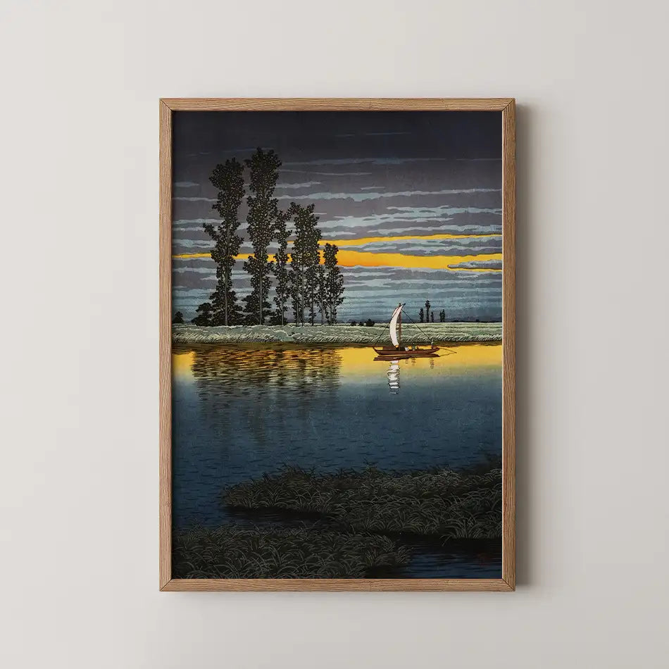 Framed painting of a serene landscape featuring a boat with a sail on calm water, surrounded by tall trees and a colorful sunset sky.