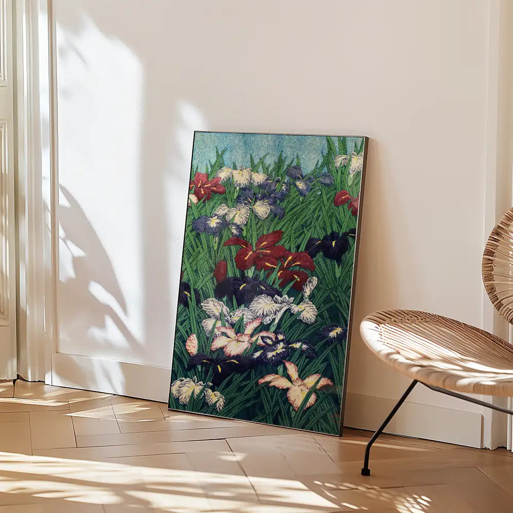 Colorful floral painting propped against a wall with a woven chair beside it.