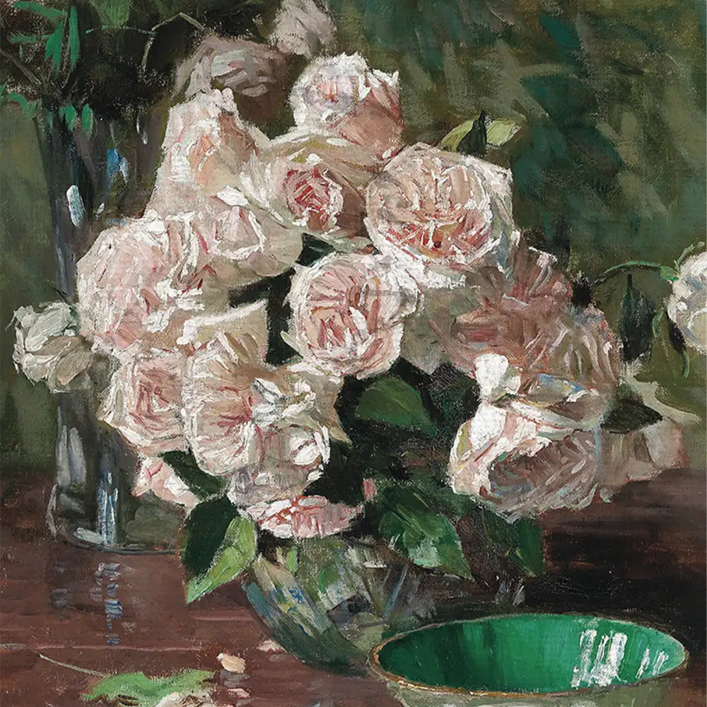 A bouquet of pale pink roses arranged in a glass vase, set against a dark green background with a green bowl visible in the foreground.