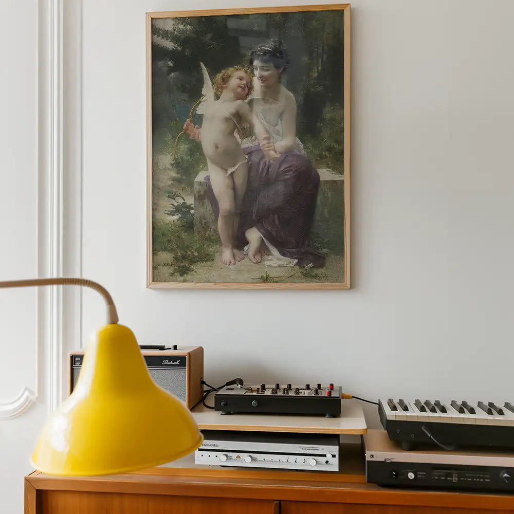 A vintage painting of a woman seated with a joyful cherub, surrounded by greenery, framed and displayed on a wall above a wooden cabinet with audio equipment and a yellow lamp.