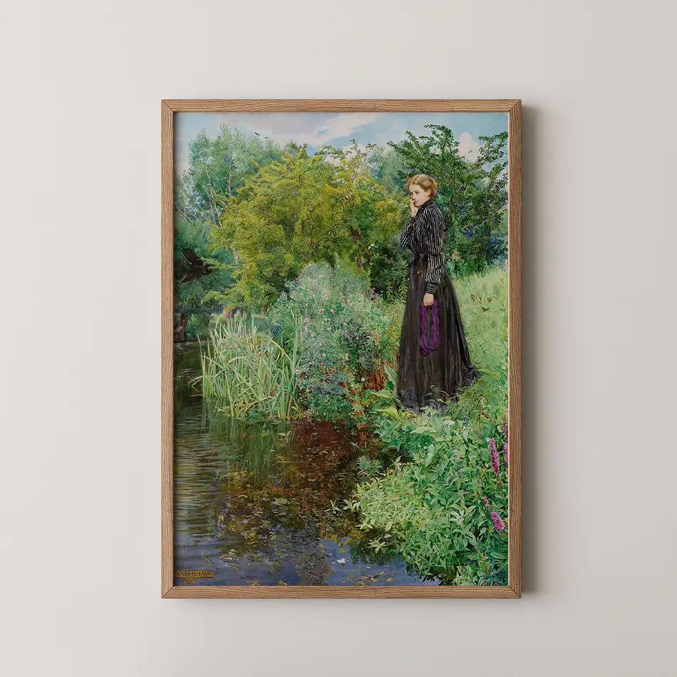 Painting of a woman in a black dress standing by a tranquil pond surrounded by lush greenery and colorful flowers, framed in natural wood.
