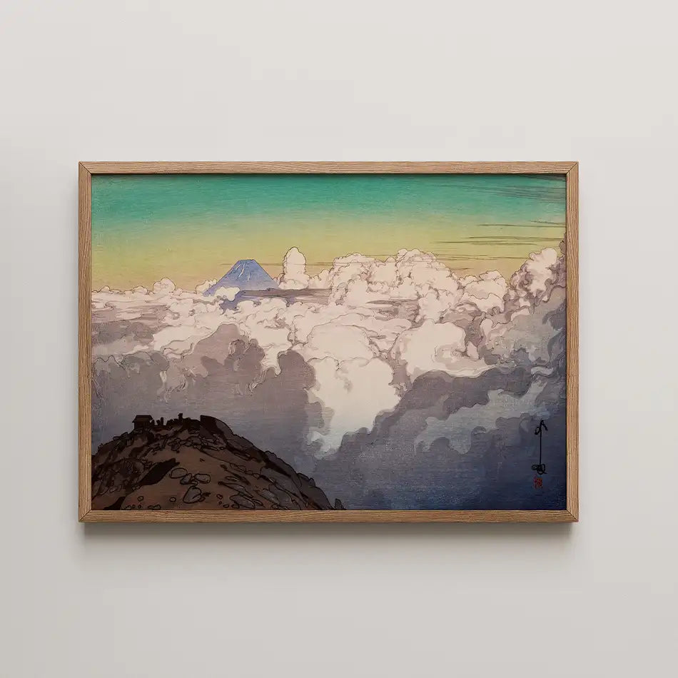 Framed painting of a mountain peak emerging from clouds, featuring a gradient sky of greens and blues.