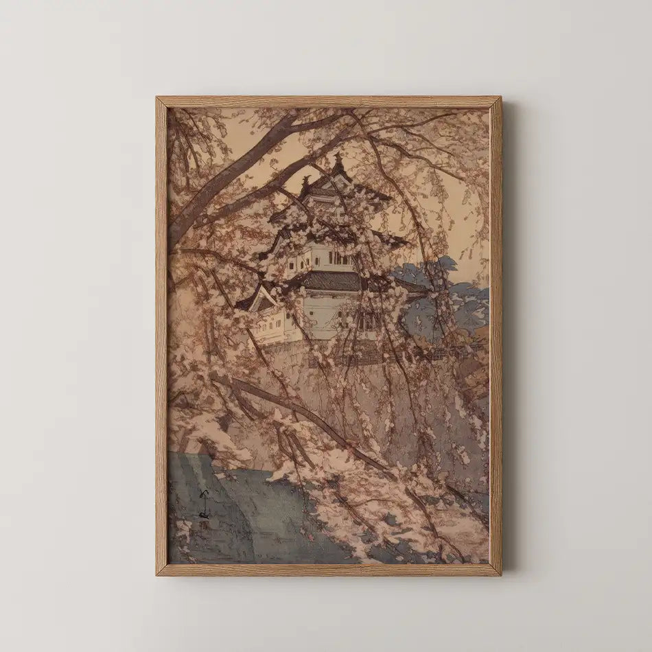 A framed painting depicting a traditional building surrounded by cherry blossom trees against a soft, muted background.