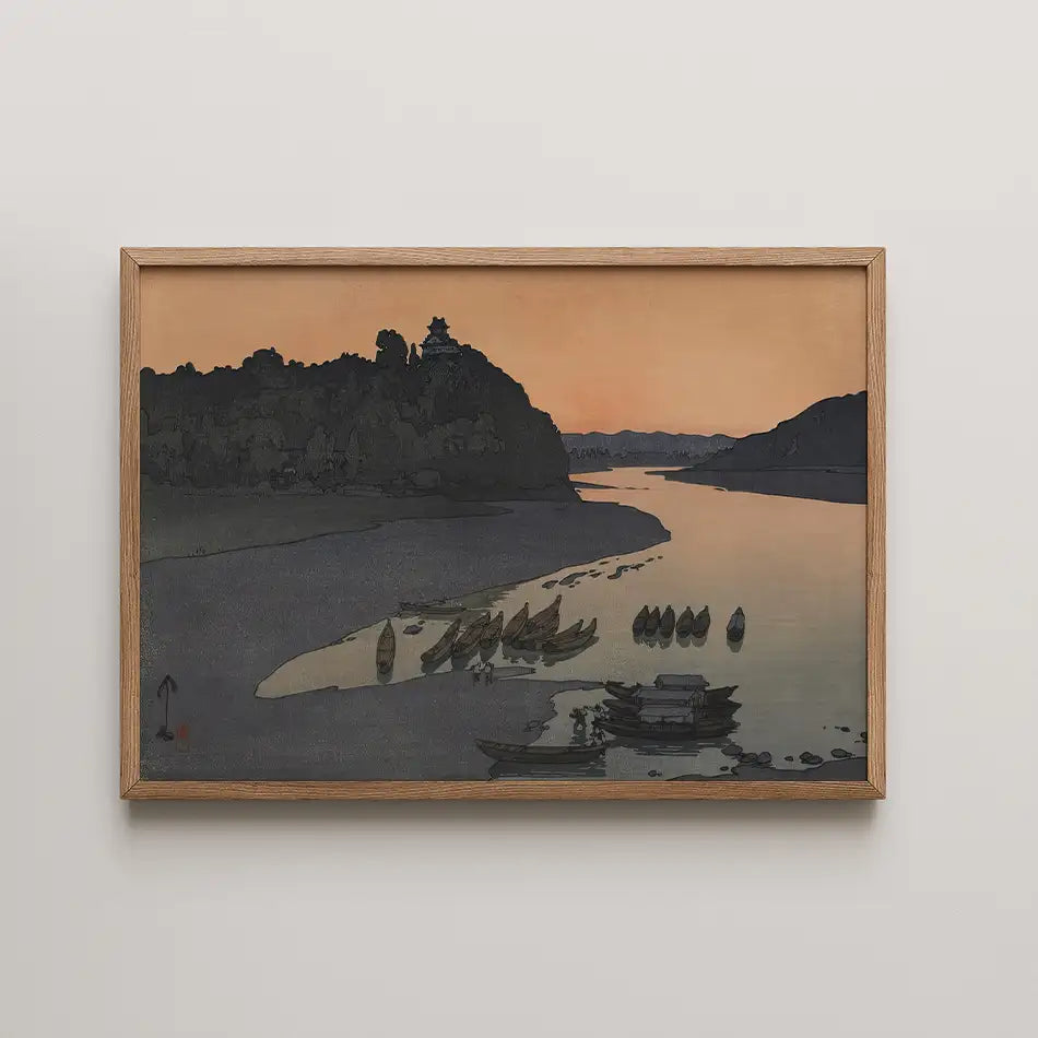 Framed painting of a serene river landscape at dusk, featuring boats along the shore and silhouetted hills in the background.