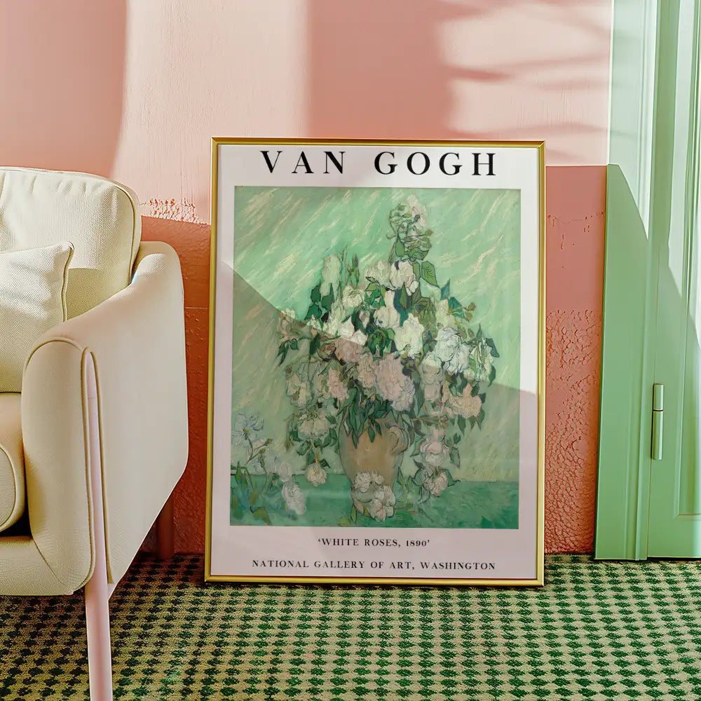 Framed poster of Vincent van Gogh's painting "White Roses" from 1890, placed against a pastel-colored wall and next to a light-colored sofa.