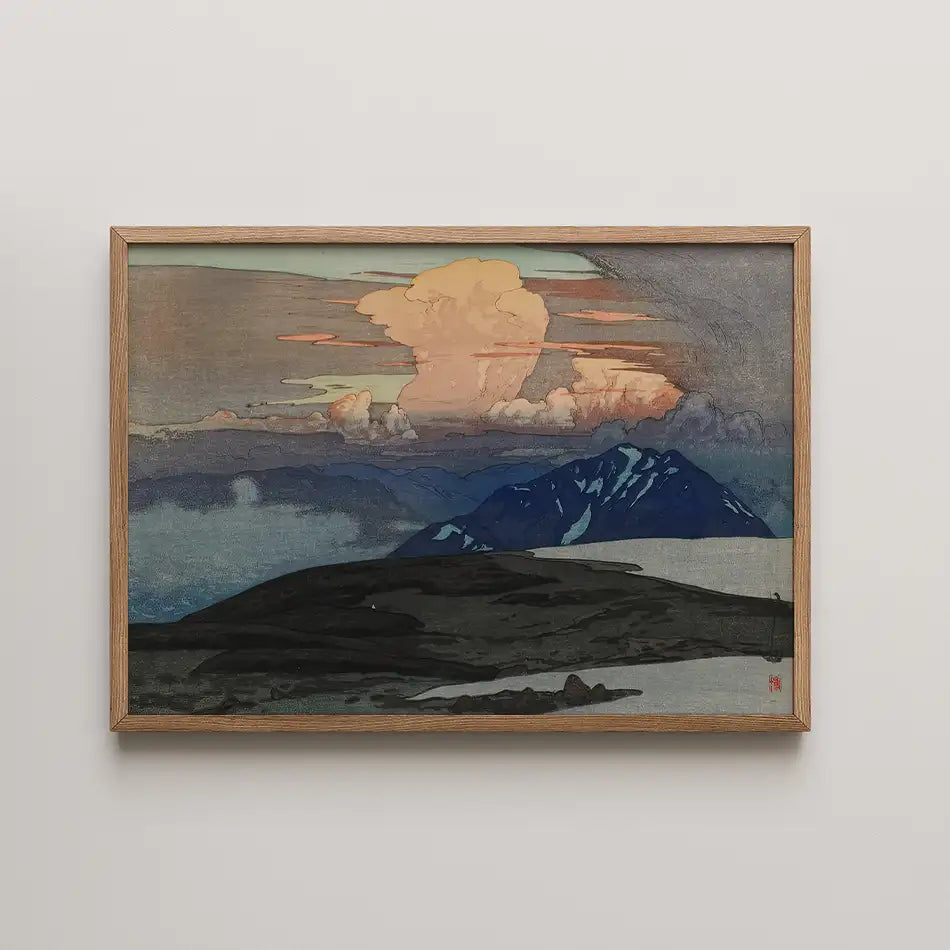 Framed painting depicting a serene landscape with mountains and clouds, featuring earthy tones and a dramatic sunset sky.