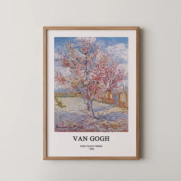 Framed artwork of Vincent van Gogh's "Pink Peach Trees" (1888) featuring a blooming peach tree against a blue sky and rural background.