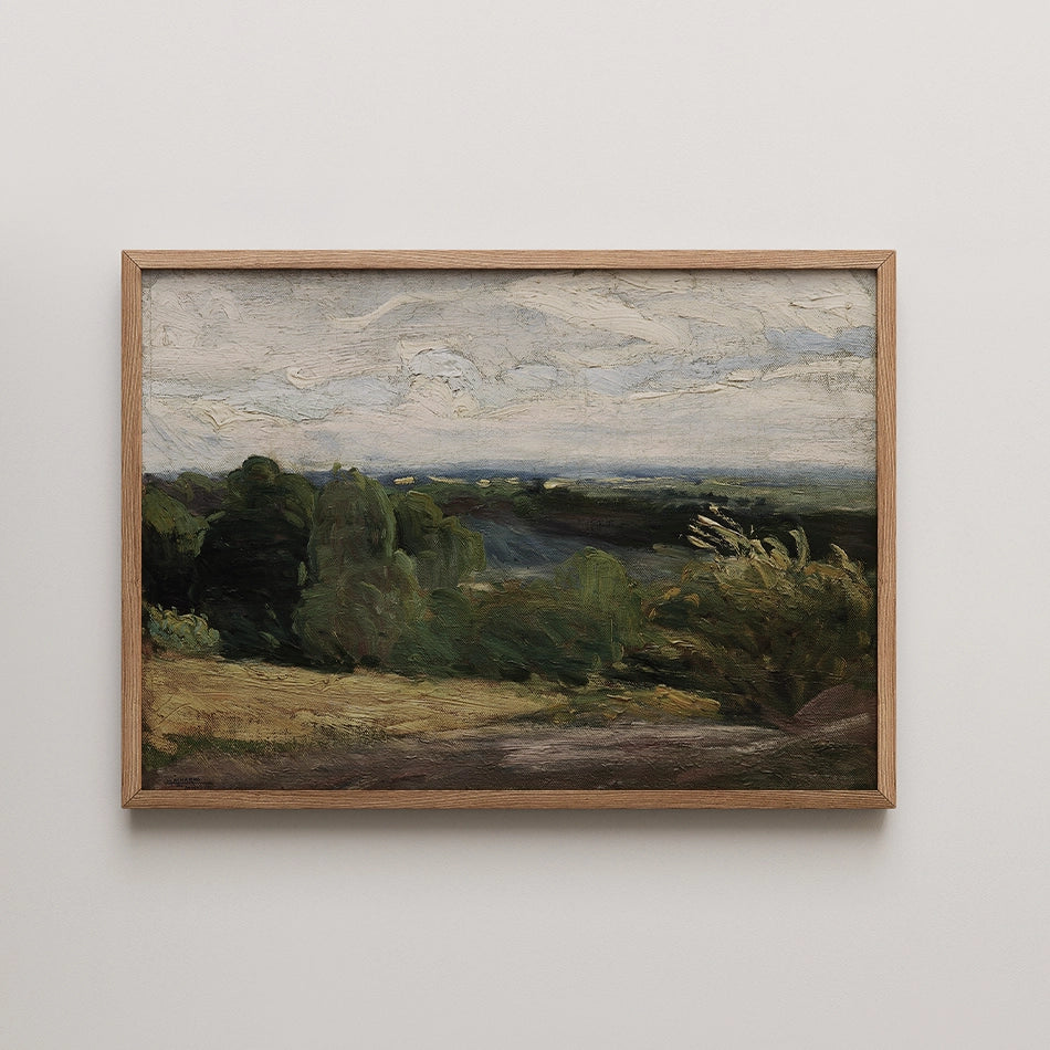 Framed landscape painting depicting green trees and rolling hills under a cloudy sky.